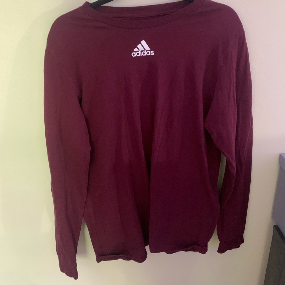Long sleeve maroon adidas shirt.